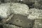   Détail du secteur méridional du chantier de la place de la Libération à Troyes (Aube), 2004-2005. Au premier plan : des vestiges gallo-romains (Ier-IIe s.) ; au deuxième plan : les fondations du mur sud (face externe) de la chapelle souterraine, édifiée au XIe s. ; à troisième plan : la chapelle souterraine.  