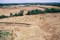 Vue de la tranchée de palissade néolithique recoupée par des enclos funéraires protohistoriques. Un groupe de sépultures protohistoriques sans enclos est visible devant la tranchée, commune de Monéteau (Yonne), 1999. 