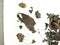 Contenu du pendentif reliquaire en argent retrouvé dans la sépulture 618 du cimetière du XVIIIe siècle à Yvetot (Seine-Maritime). Il contenait des restes humains (cheveux, peau, os) et textiles. Ces derniers remarquablement fins attestent un certain luxe, compte tenu des techniques mises en œuvre et des matériaux employés (notamment un fond de soie rehaussé de fil d'or). 