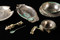 Une partie du dépôt d'argenterie découvert dans une cave gallo-romaine, IIe-IIIe s. de notre ère, fouille du tramway à Reims (Marne), 2009.  Composé de vaisselle de bronze revêtue d'une tôle d'argent, le dépôt comprend deux plats ronds dont un à décor perlé, deux plats ovales à marli horizontal et décor gravé, une coupe à collerette, un plat rond contenant une coupelle retournée et quatre cuillères d'argent et de bronze.  